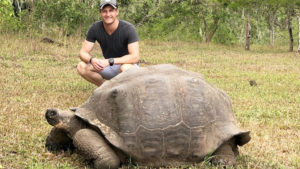 Chris-Nicholson-with-giant-tortoise-in-Galapagos-Islands