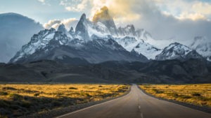 Open road leading toward mountain range