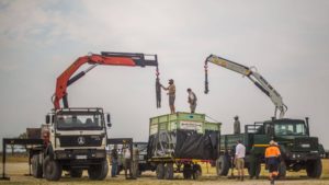 Cranes on trucks off loading rhino for free release