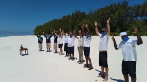 Mnemba Island team wearing masks for guest arrival