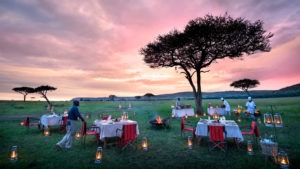 A romantic lantern-lit al fresco bush dinner in the Masai Mara's wilderness