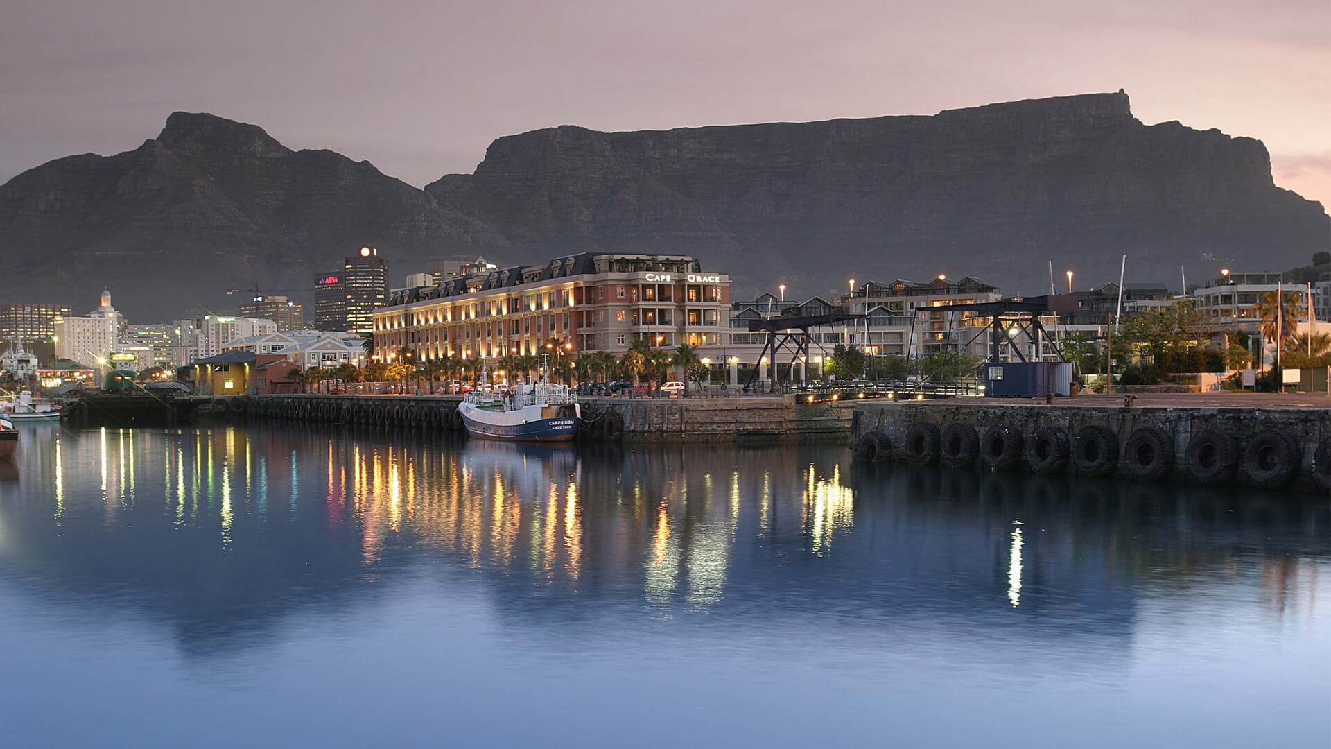 Evening view of the iconic Cape Grace Hotel with Table Mountain in the background