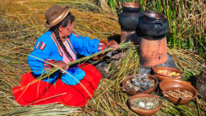 Pachamanca traditional dish cooked by Peruvian woman on Uros Island