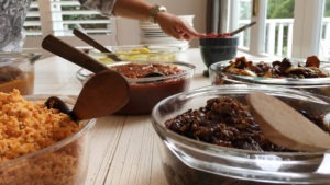 The host points to various dishes at a private cooking lesson in Colombo