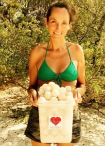 claire trickett from andbeyond with a bucket full of turtle eggs at andbeyond mnemba