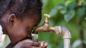 girl drinking water from tap