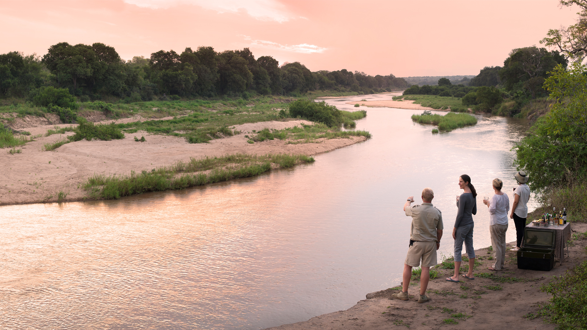 guide pointing to river on aprivate jet expedition with andbeyond