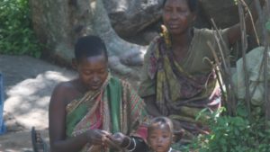 hadzabe family sitting under a tree