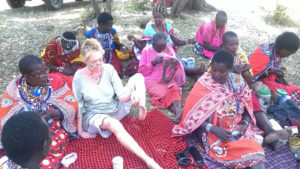 joanne brooks showing maasai ladies how she works with her feet