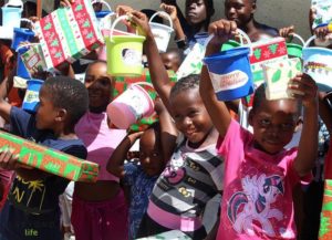 local community kids holding christmas gifts from andbeyond kirkmans