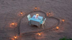 romantic dining in the sand river at andbeyond ngala