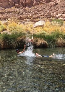 swimming in the puritama hot springs in south america